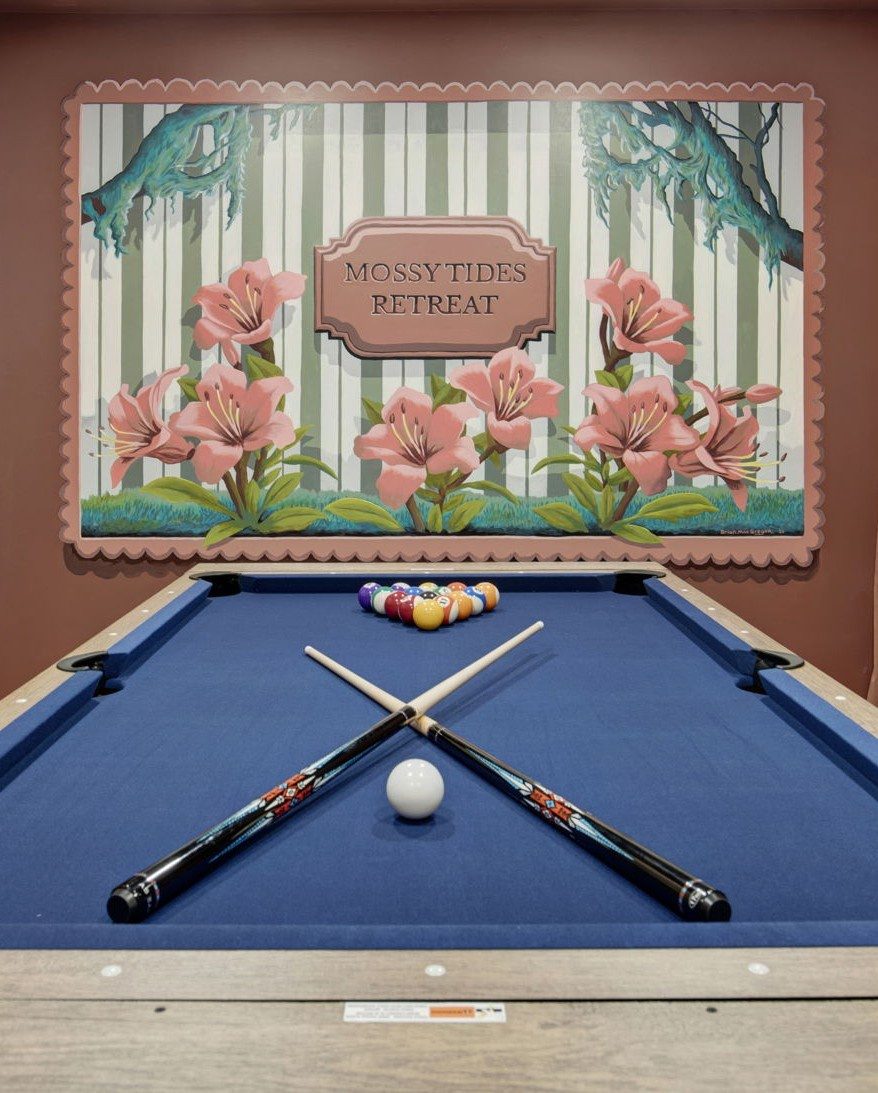 Game room with a custom floral mural and pool table at Mossy Tides Retreat — Whitemarsh Island, Savannah Georgia
